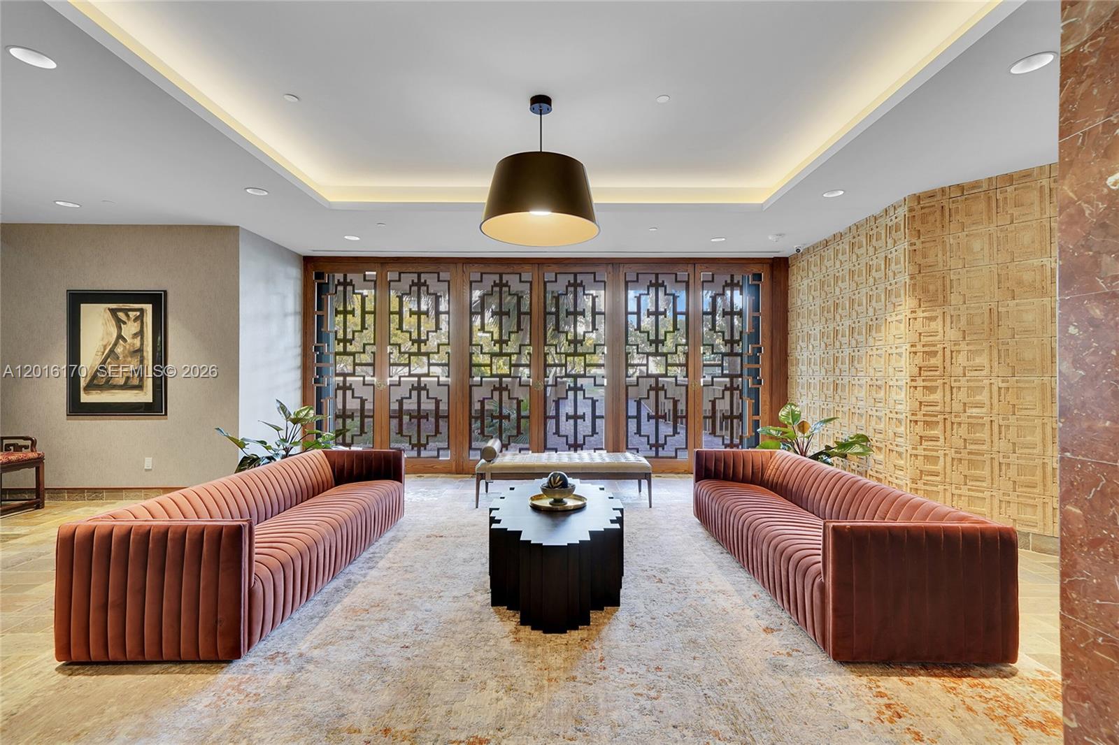 A formal lobby features two velvet sofas, a central coffee table, and decorative wooden screens — 11113 Biscayne Blvd # 255, Miami FL 33181, MIAMI, FL