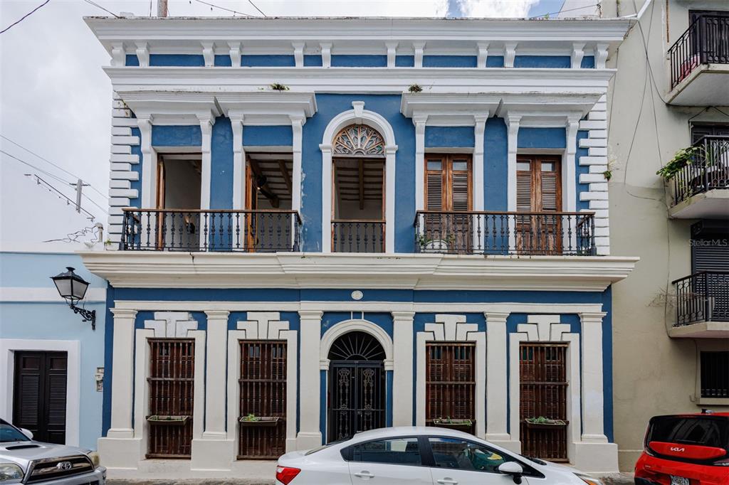 A two-story blue and white colonial building features a balcony and arched doorways — 364 CALLE SOL UNIT 2B, OLD SAN JUAN, PR