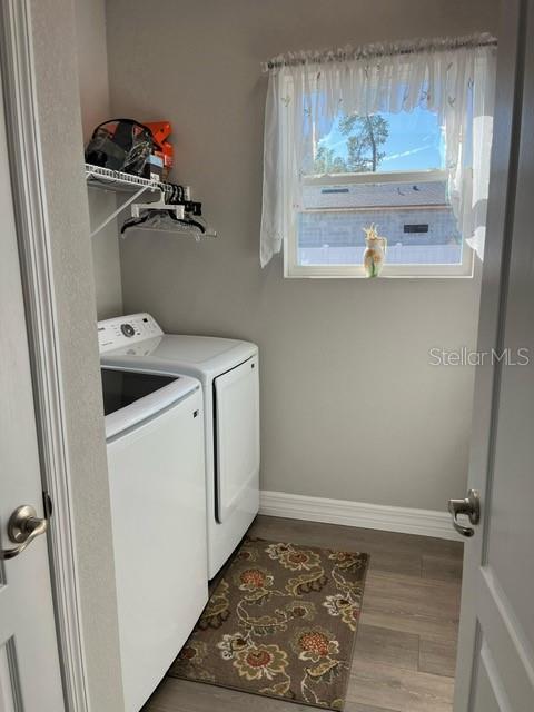 A laundry room features white appliances, a wire shelf, and a window with a curtain — 15610 SW 40TH TERRACE, OCALA, FL