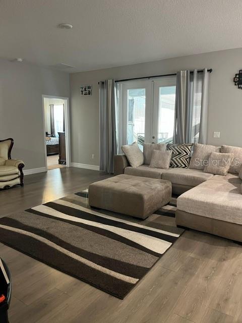A living room features a sectional sofa, a large ottoman, and a patterned area rug — 15610 SW 40TH TERRACE, OCALA, FL
