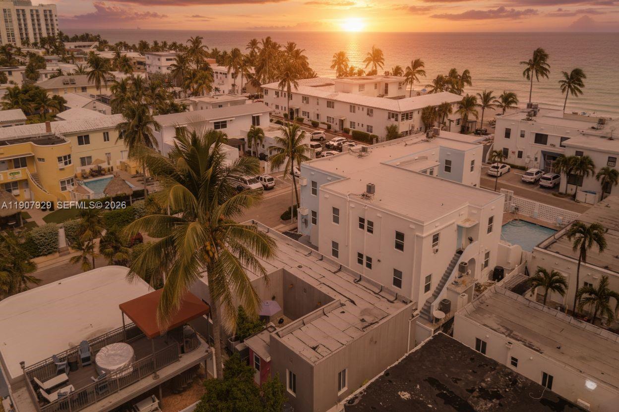 An aerial view shows white apartment buildings near a beach at sunset — 322 Oklahoma St, Hollywood FL 33019, HOLLYWOOD, FL