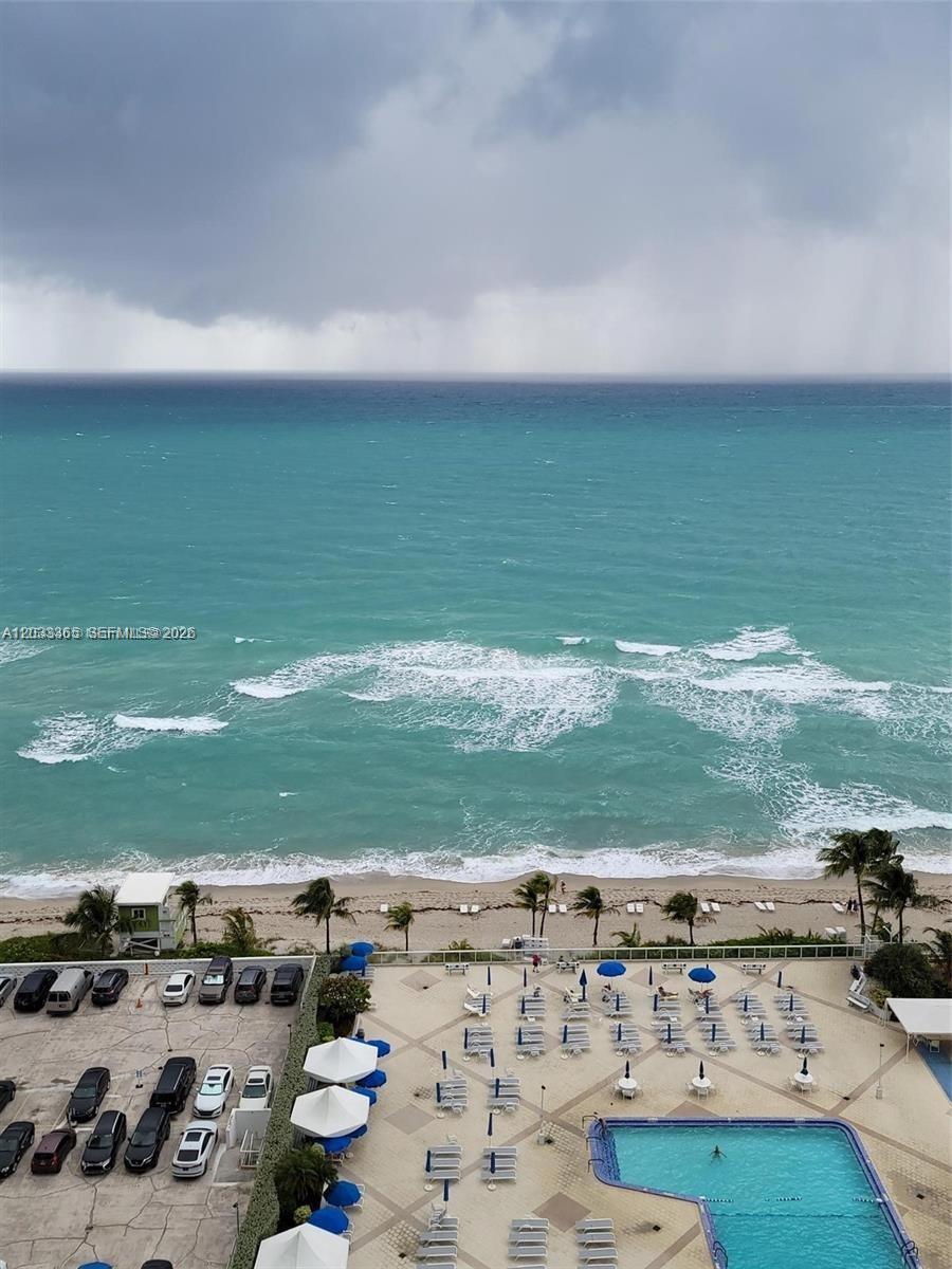 An elevated view shows a beach, ocean, and a pool deck with lounge chairs — 2030 S Ocean Dr # 1815, Hallandale Beach FL 33009, HALLANDALE BEACH, FL