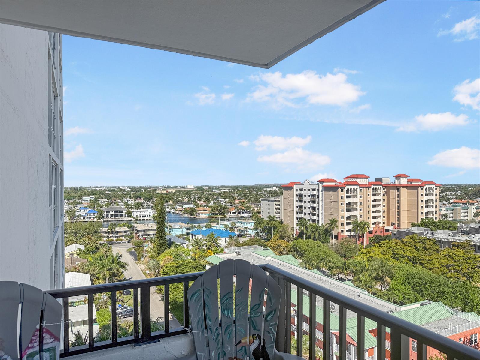 A high-angle view from a balcony overlooking a residential area with buildings and water — 531 N Ocean Boulevard # 1203, Pompano Beach FL 33062, POMPANO BEACH, FL