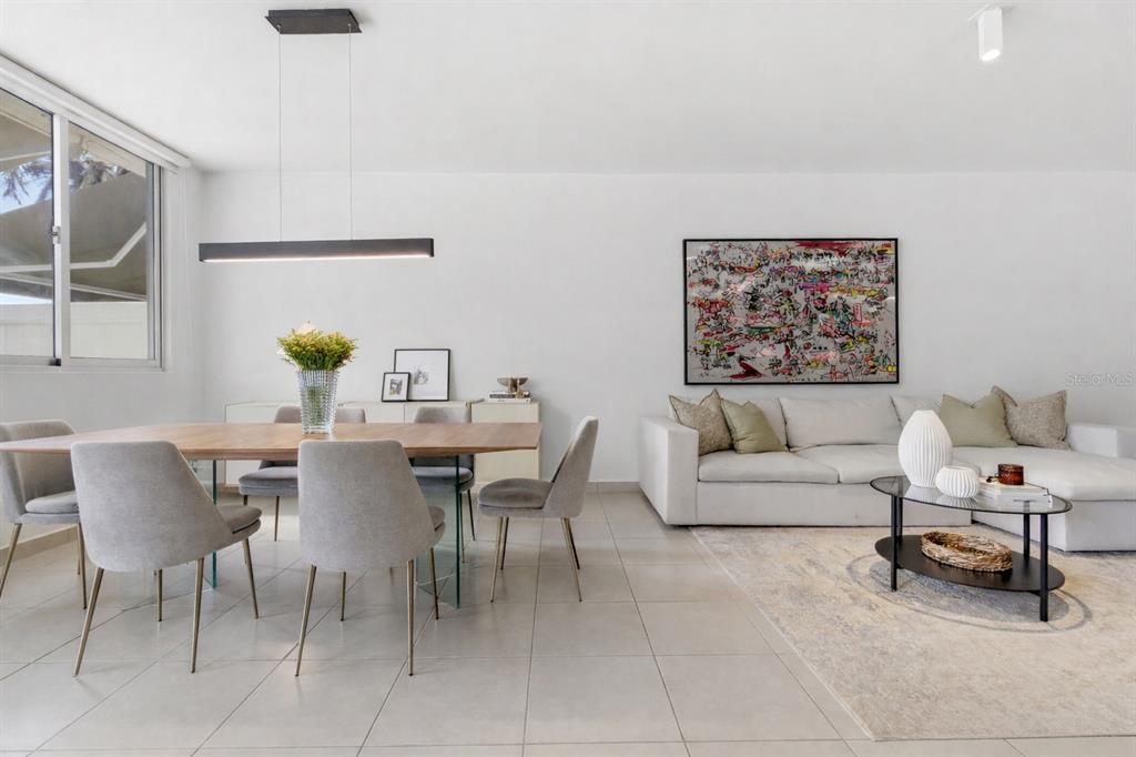 A modern open-concept living and dining room with white walls, tile floors, and contemporary furniture — 111 CALLE 3, GUAYNABO, PR