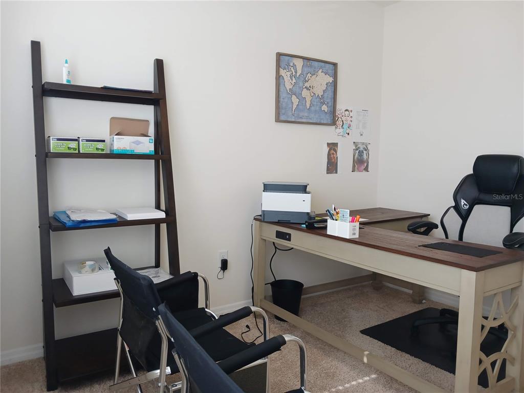 A home office features a wooden ladder shelf, an L-shaped desk, and a gaming chair — 563 HONEY BELL ROAD, WINTER HAVEN, FL