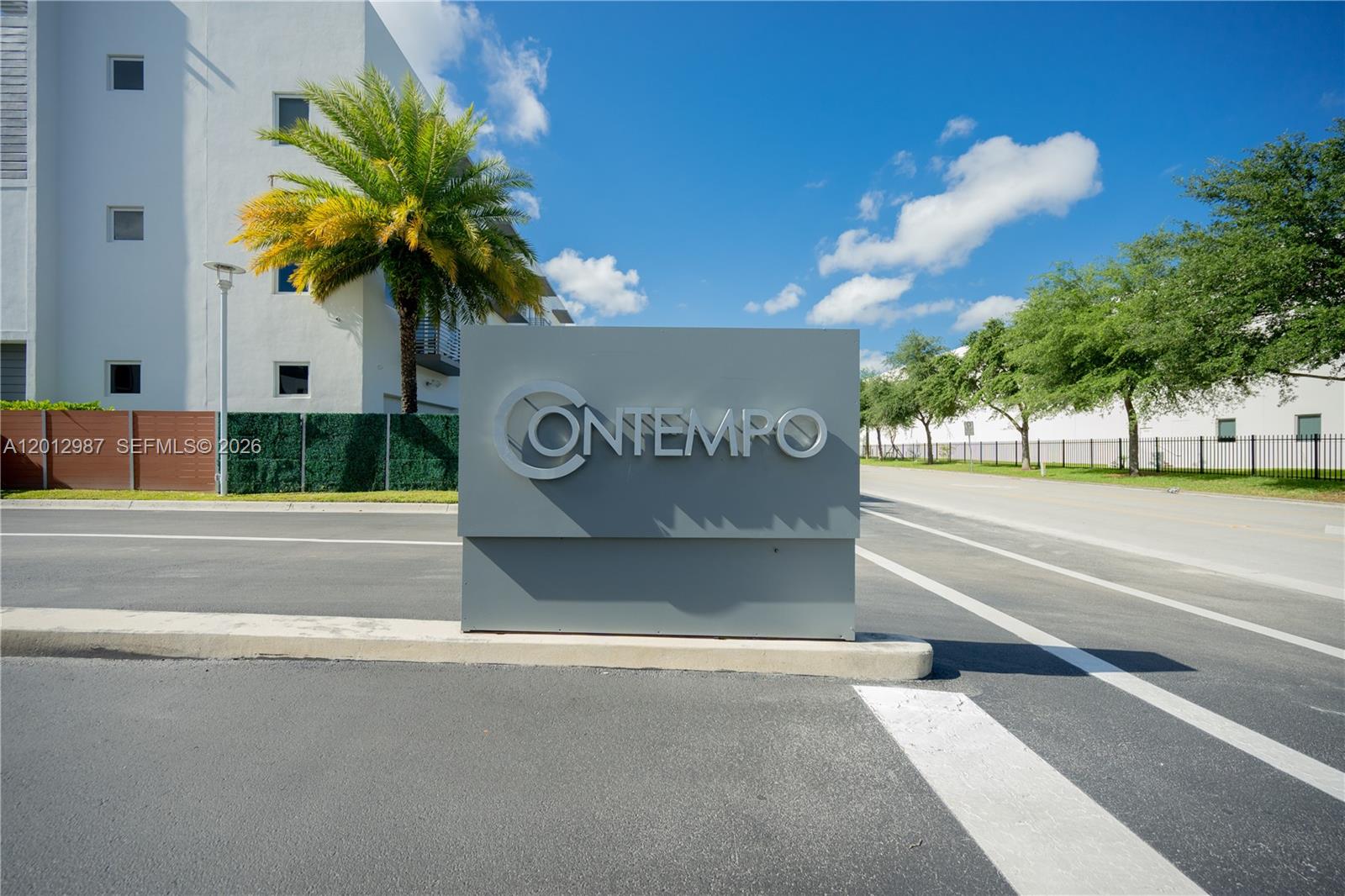 A gray sign with the name Contempo stands at the entrance of a residential complex — 9165 NW 33rd St, Doral FL 33172, DORAL, FL