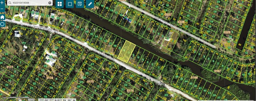 This is a satellite map view showing residential lots along a canal and local roads — 27406 SAN CARLOS DRIVE, PUNTA GORDA, FL