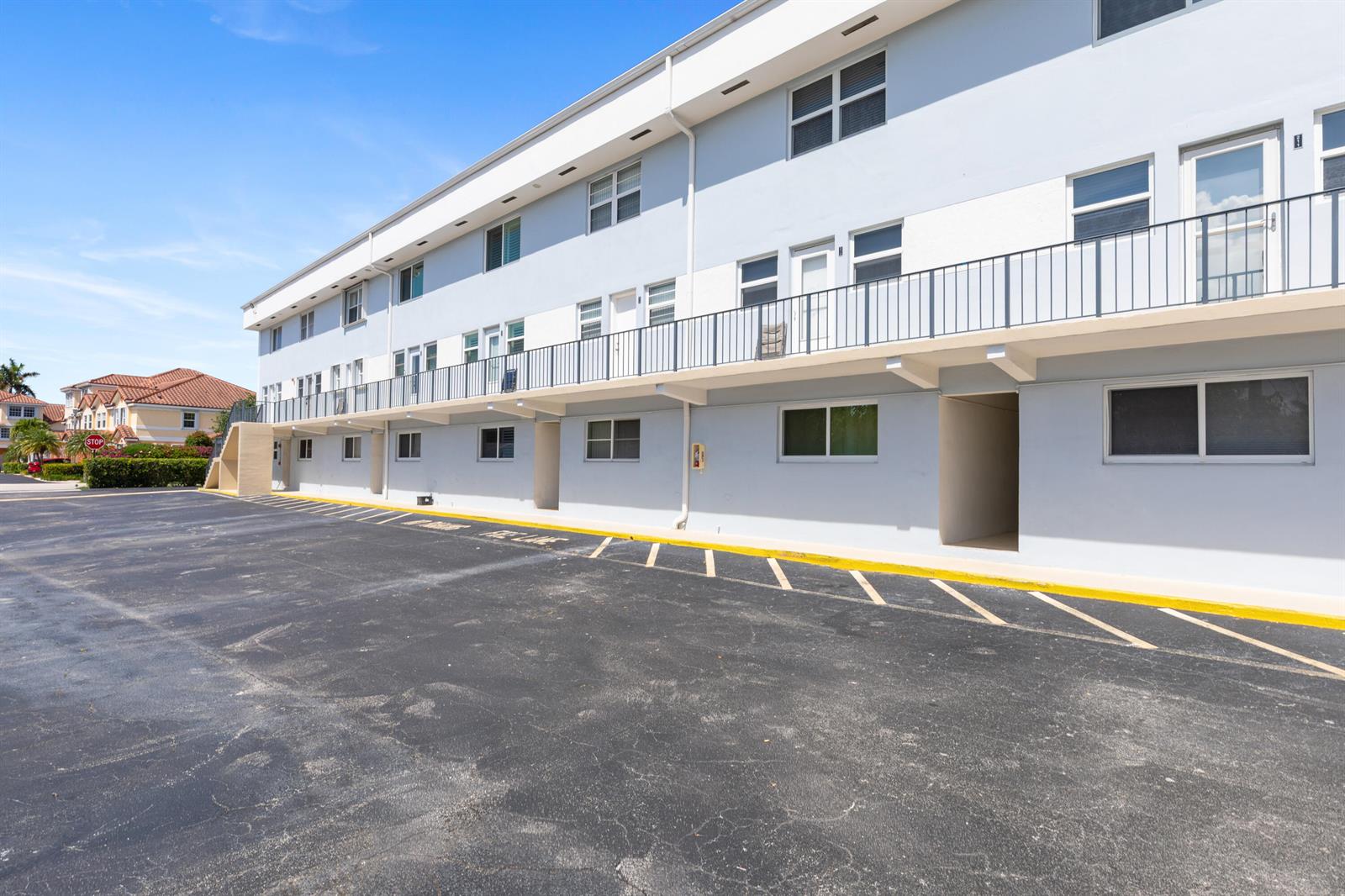A three-story apartment building with a parking lot and a second-floor balcony — 505 NE 20th Avenue # 112, Deerfield Beach FL 33441, DEERFIELD BEACH, FL