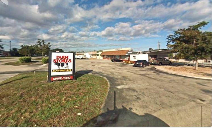 A Farm Stores Express drive-thru building sits on a paved lot under a cloudy sky — 7761 JOHNSON STREET, PEMBROKE PINES, FL