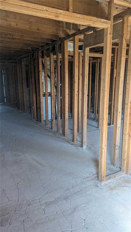 An unfinished basement interior features exposed wooden wall studs and a cracked concrete floor — 4087 LAKE BAYSHORE DRIVE UNIT 312, BRADENTON, FL