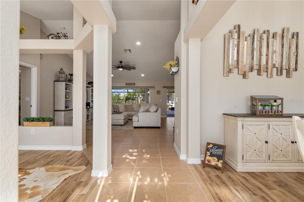 A single-story house with a tan stucco exterior, a brown roof, and a paved driveway — 8251 ARLEWOOD CIRCLE, PORT CHARLOTTE, FL