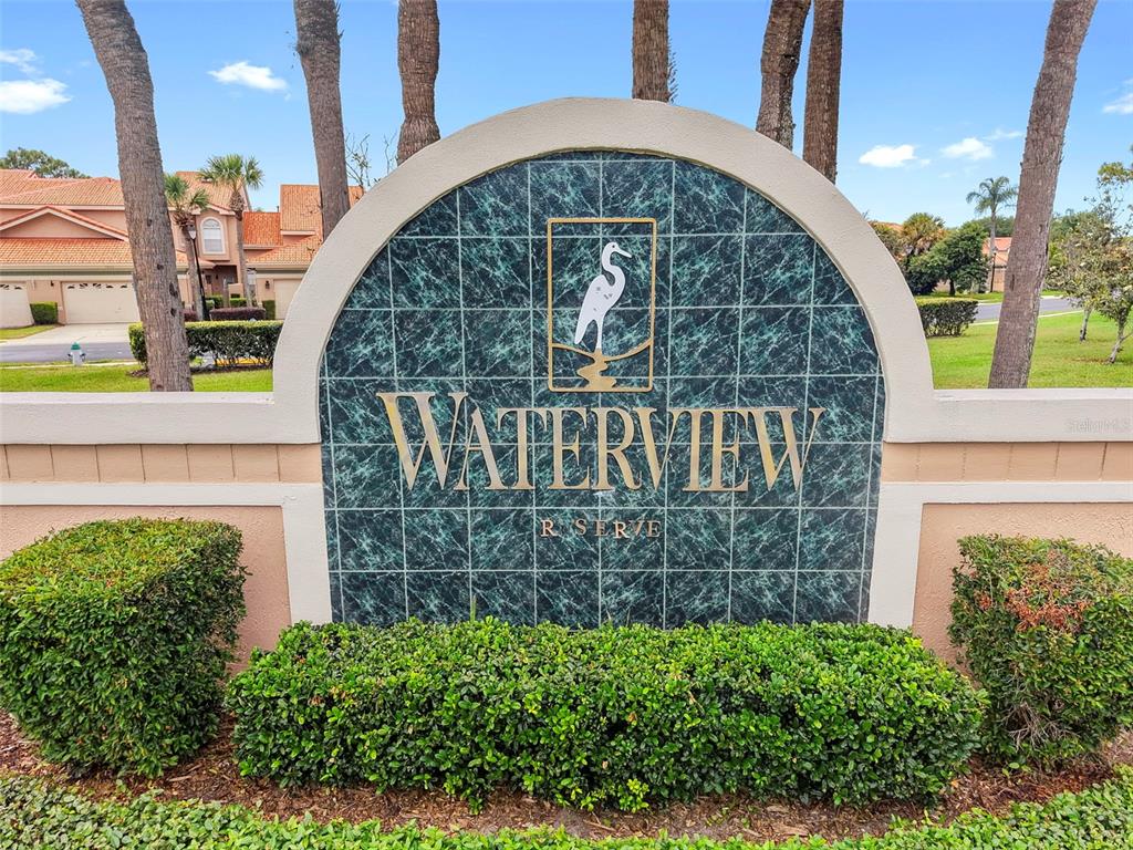 A sign for Waterview Reserve stands in front of a residential building with palm trees — 4850 WATERVISTA DRIVE, ORLANDO, FL