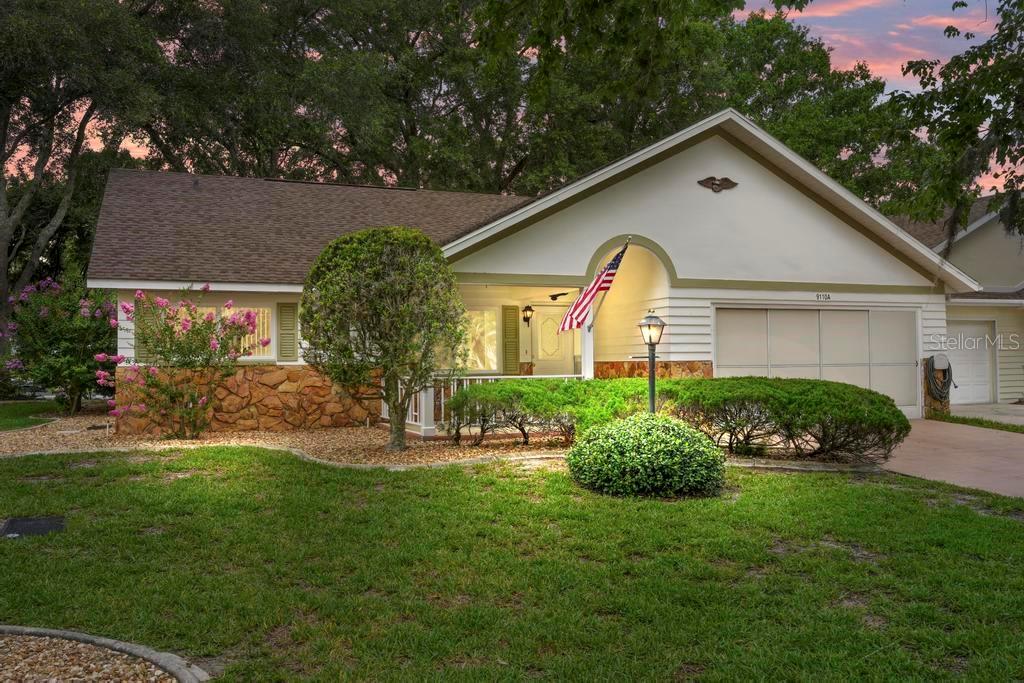 A single-story house with a stone facade, a front porch, and a two-car garage — 9110 SW 89TH TERRACE UNIT A, OCALA, FL