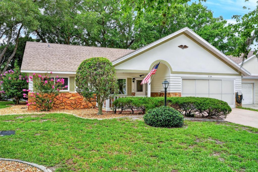 A single-story house with a stone facade, a two-car garage, and a front porch — 9110 SW 89TH TERRACE UNIT A, OCALA, FL