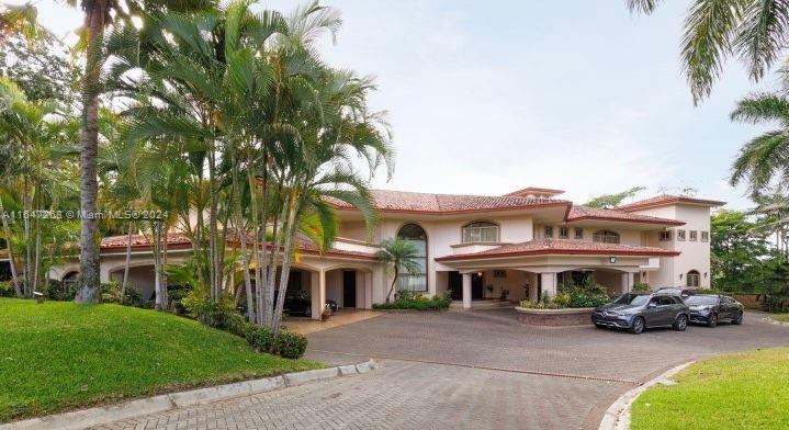 A large, two-story Mediterranean-style house with a tile roof and a paved circular driveway — San Rafael Escazu San Jose Prov. Escazu, CR, CR