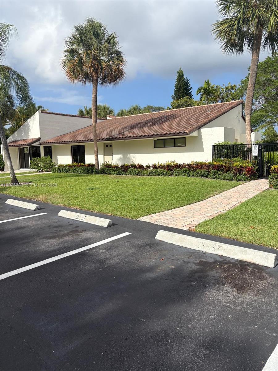 A dining area features a glass-topped table, white chairs, tile floors, and sliding glass doors — 7200 NW 2nd Ave # 1180, Boca Raton FL 33487, BOCA RATON, FL