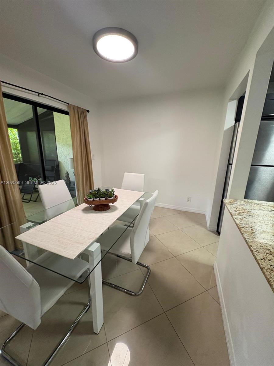 A spacious room features terracotta tile flooring, vaulted ceilings, and large sliding glass doors — 7200 NW 2nd Ave # 1180, Boca Raton FL 33487, BOCA RATON, FL