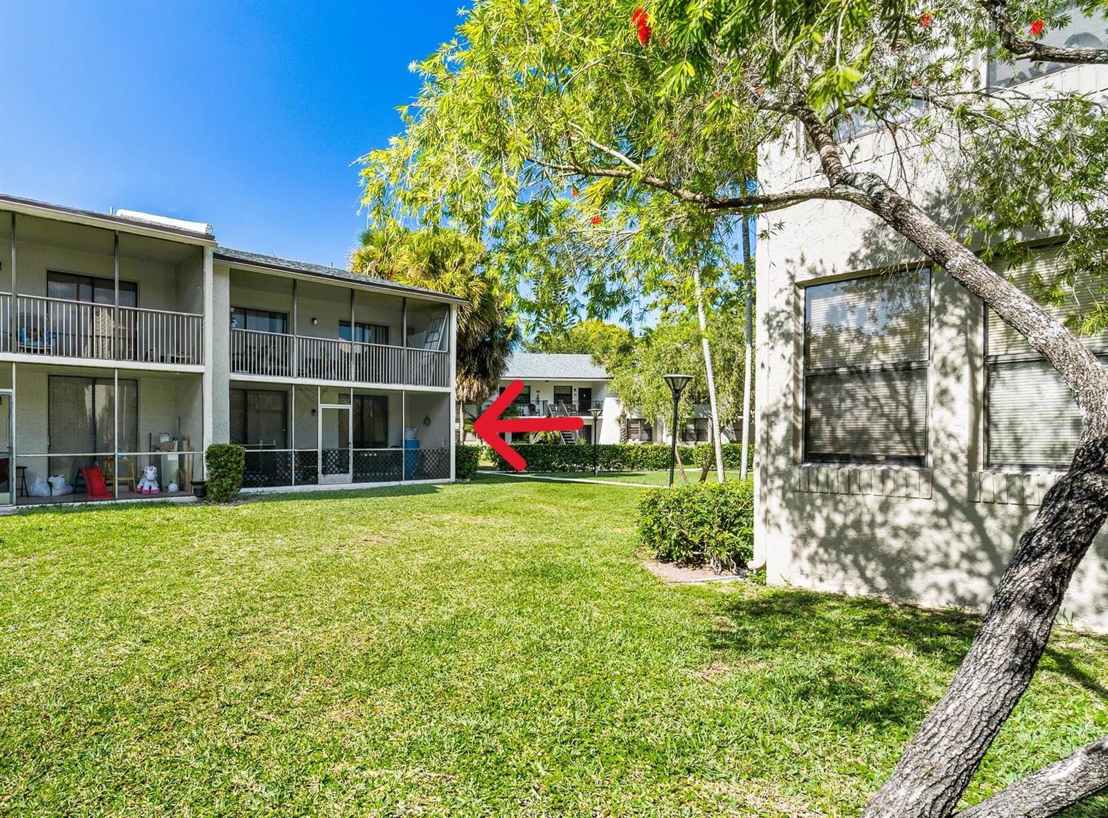 Exterior view of apartment buildings with screened-in balconies overlooking a grassy courtyard — 1230 S Military Trail # 2011, Deerfield Beach FL 33442, DEERFIELD BEACH, FL