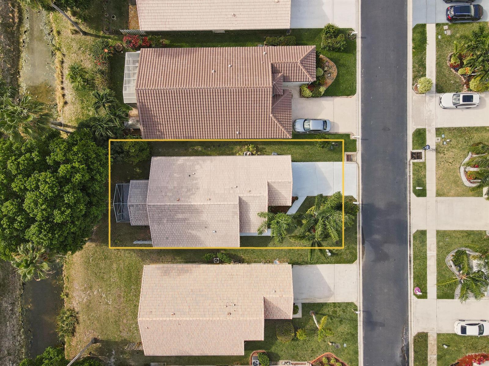 An aerial view shows a single-family home with a tiled roof and a concrete driveway — 1868 Barnstable Road, Wellington FL 33414, WELLINGTON, FL