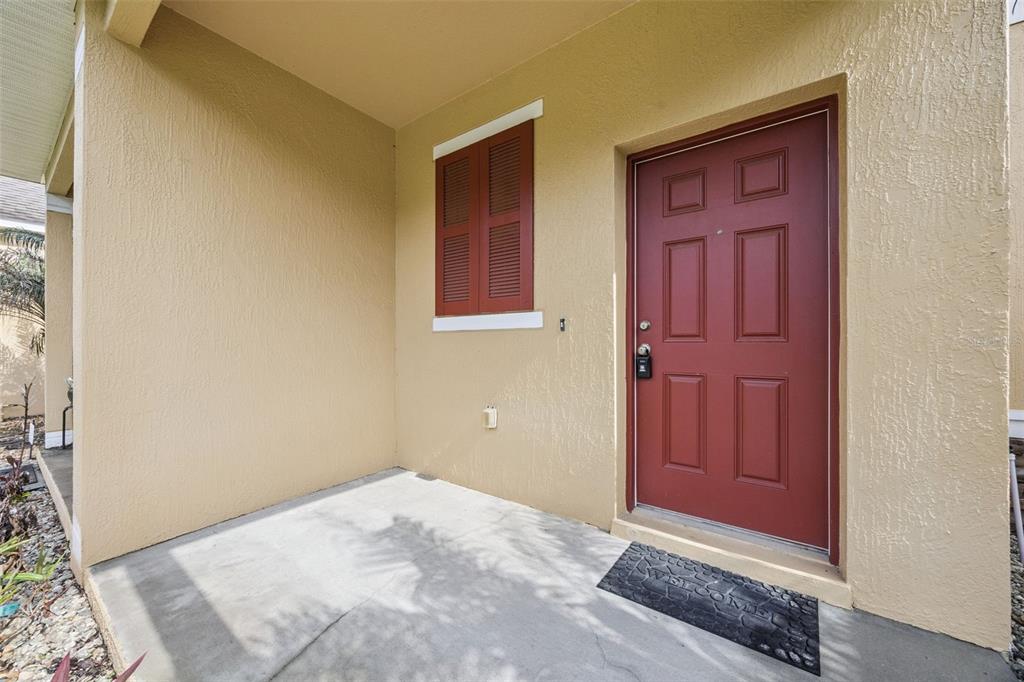 A row of two-story yellow townhouses with red shutters and a shared front lawn — 1732 BUCKEYE FALLS WAY, ORLANDO, FL