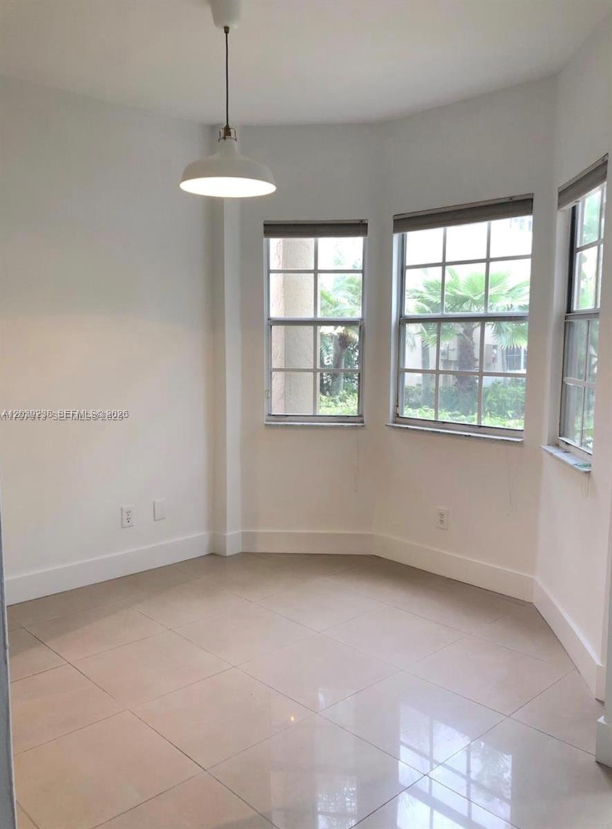 A bright dining nook features large windows, white walls, and light-colored tile flooring — 16231 Emerald Cove Rd # 0, Weston FL 33331, WESTON, FL
