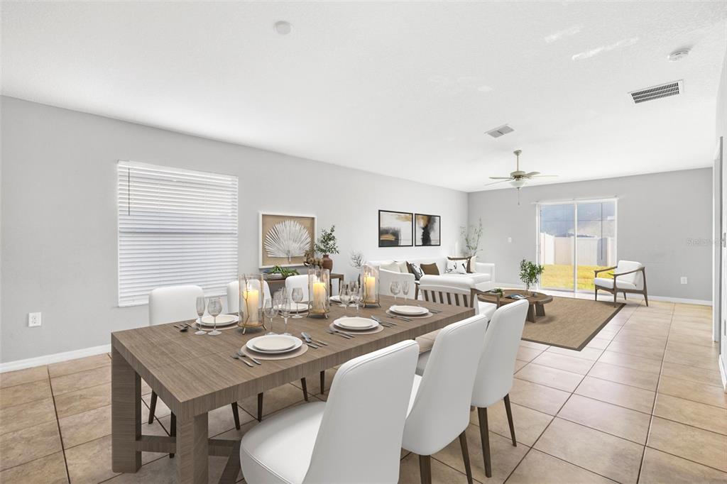 A dining area with a wooden table leads into a living room with tile floors — 6810 TRENT CREEK DRIVE, SUN CITY CENTER, FL