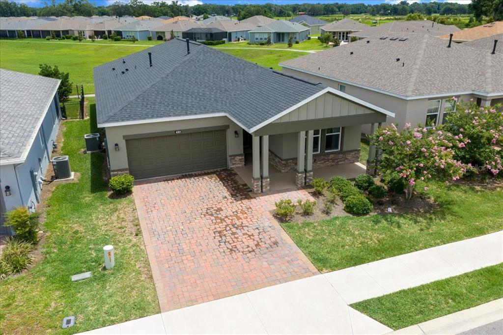 An aerial view of a single-story house with a brick driveway and gray roof — 4351 NW 54TH TERRACE, OCALA, FL