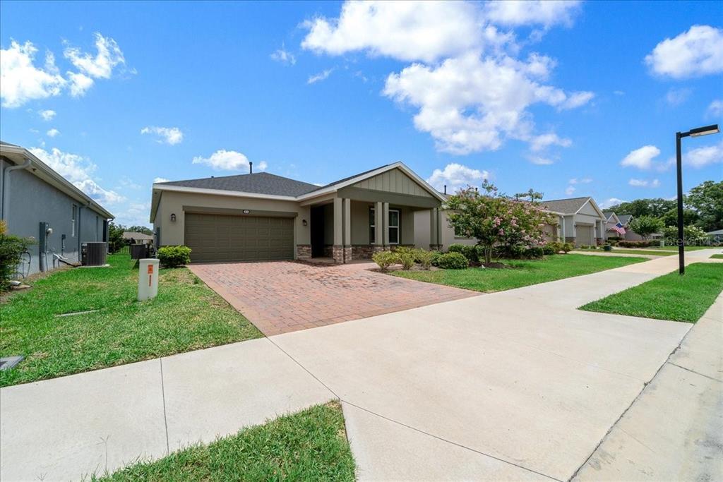 A single-story house with a brick driveway, two-car garage, and a covered front porch — 4351 NW 54TH TERRACE, OCALA, FL