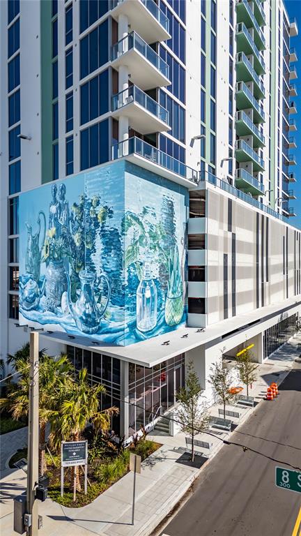 A tall modern apartment building features a large blue mural of still-life objects — 777 3RD AVENUE N UNIT 1603, ST PETERSBURG, FL