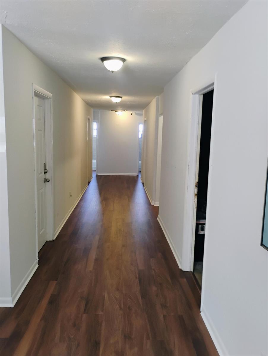 A long hallway features wood-look flooring, white walls, and three ceiling-mounted light fixtures — 803 SE Tarpon Avenue SE, Stuart FL 34994, STUART, FL