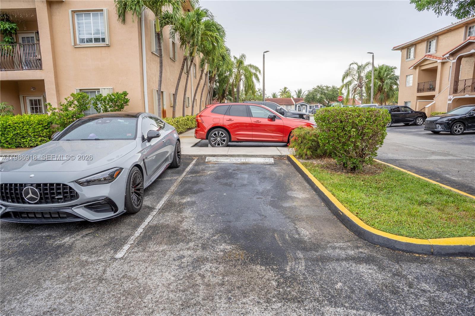 A gray Mercedes-Benz is parked in a lot next to a red SUV — 17425 NW 75th Pl # 101, Hialeah FL 33015, HIALEAH, FL