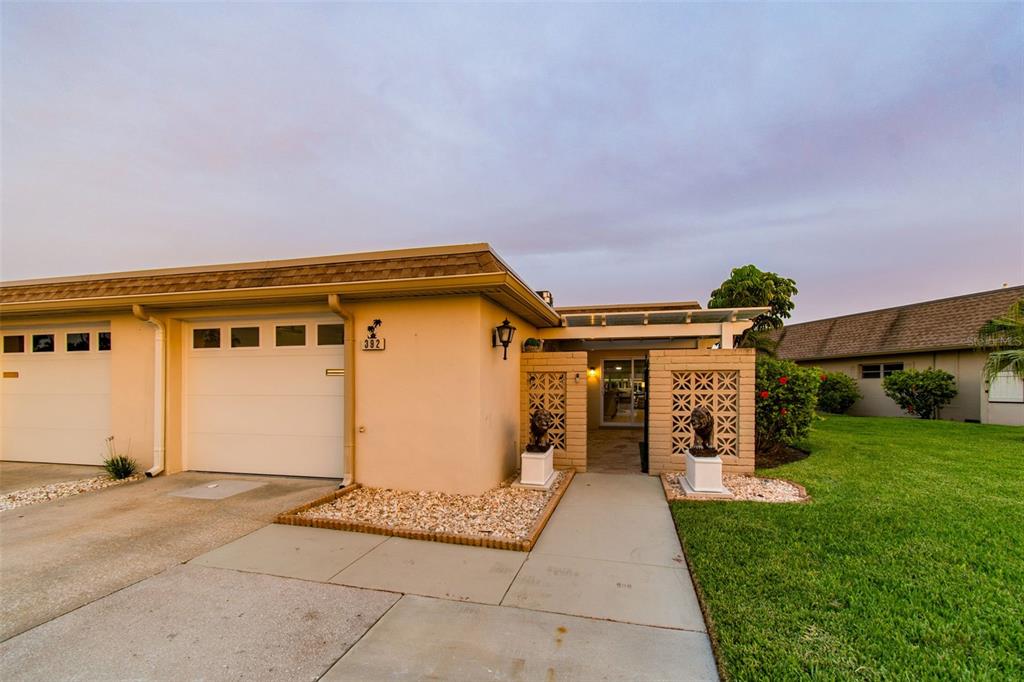 A single-story residential building with a garage, a walkway, and decorative concrete block walls — 392 BOCA CIEGA POINT BOULEVARD N, ST PETERSBURG, FL