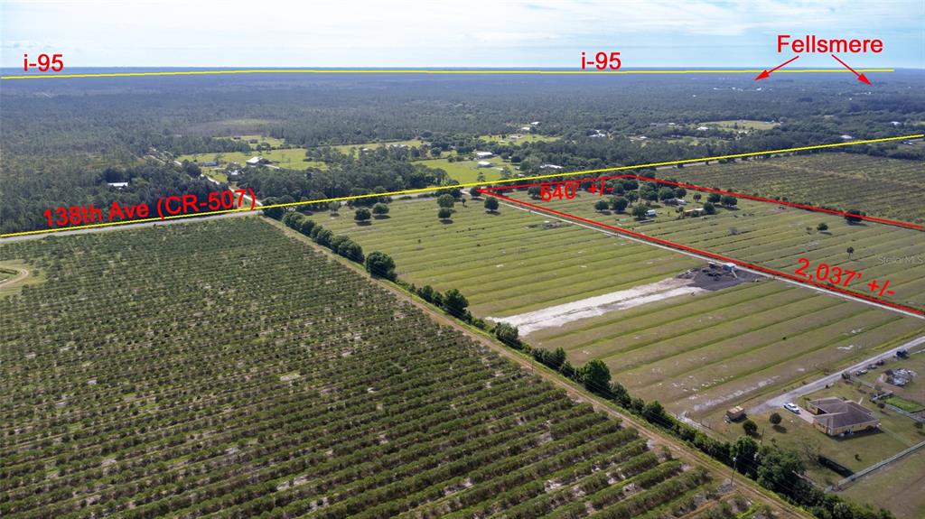 An aerial view shows a large, rectangular plot of land outlined in red near a road — 11525 138TH AVENUE, FELLSMERE, FL