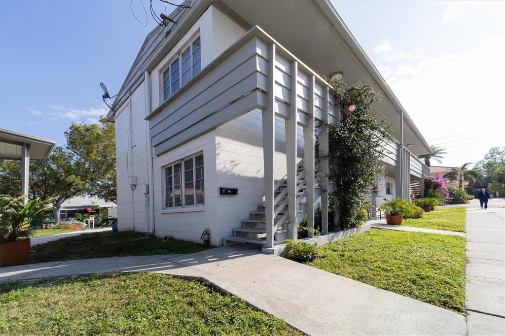 A two-story white apartment building with an exterior staircase and a concrete walkway — 1901 HYDE PARK STREET UNIT C, SARASOTA, FL