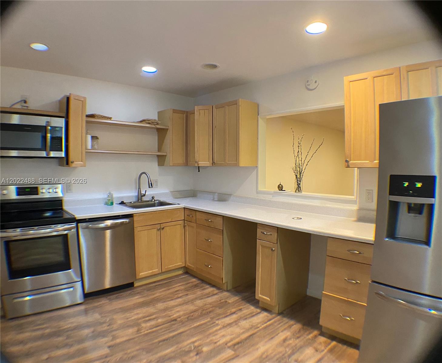 A kitchen features light wood cabinets, stainless steel appliances, and white countertops — 2061 NW 47th Ter # 302, Lauderhill FL 33313, LAUDERHILL, FL