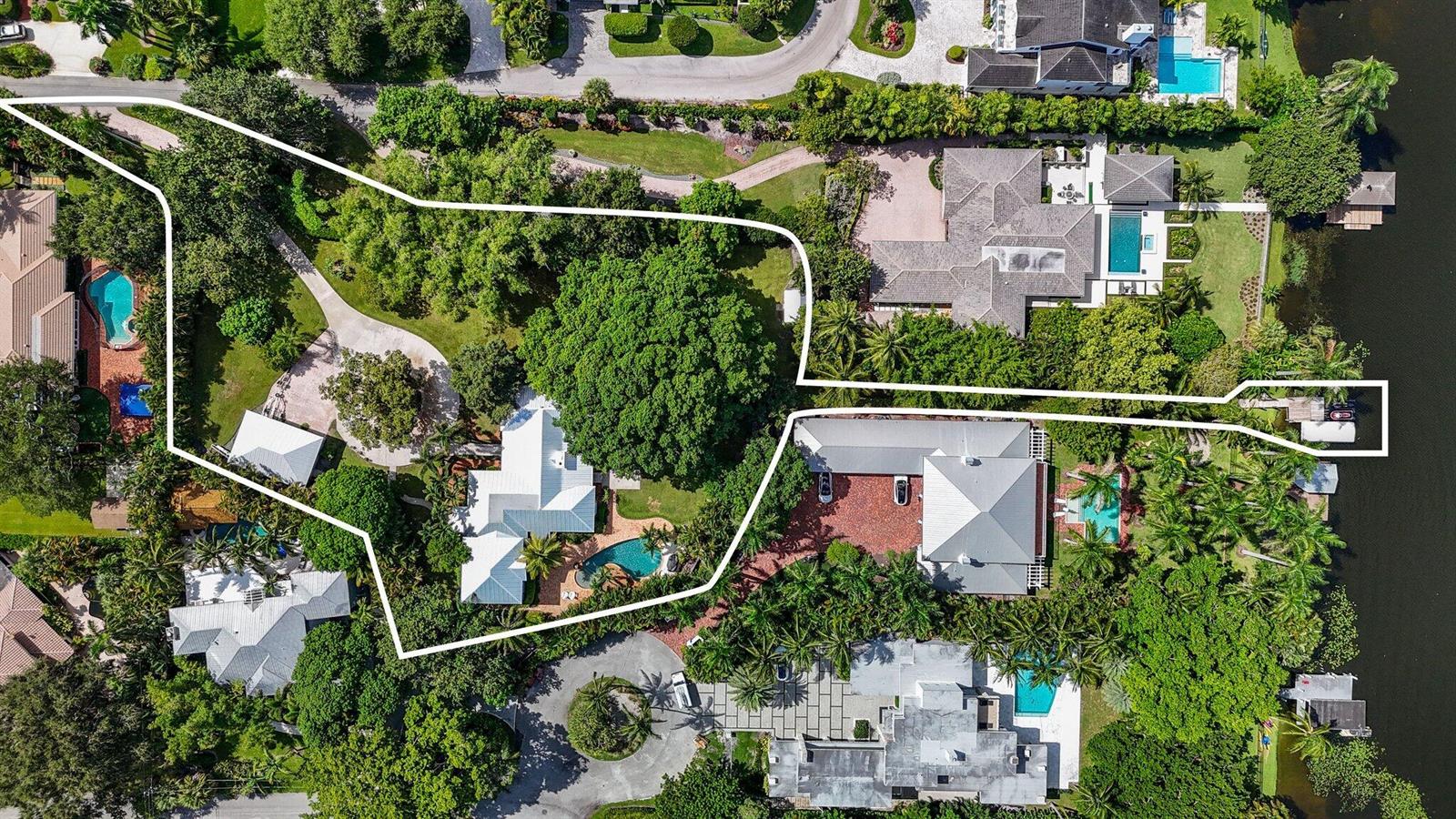 An aerial view shows a residential property with a large house, pool, and private dock — 920 Hibiscus Lane, Delray Beach FL 33444, DELRAY BEACH, FL