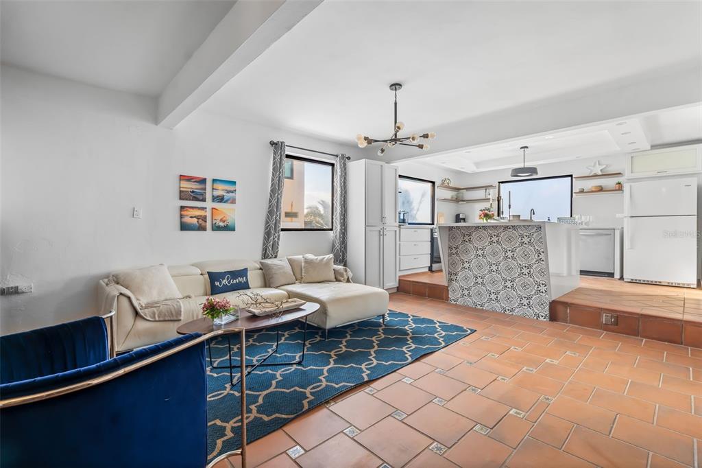 An open-concept living room and kitchen featuring terracotta tile floors and a patterned tile island — 91 G KENNEDY STREET, DORADO, PR