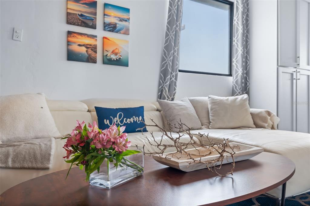 A living room features a white sectional sofa, a coffee table with flowers, and wall art — 91 G KENNEDY STREET, DORADO, PR
