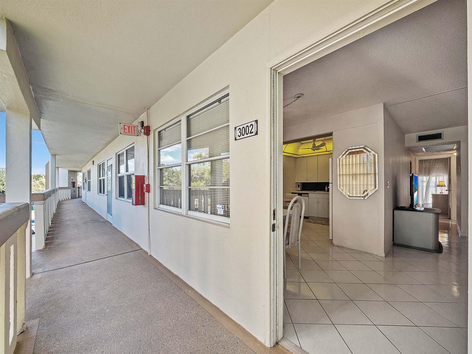 An exterior walkway leads to the entrance of a condo unit with tiled floors — 3002 Ventnor # G, Deerfield Beach FL 33442, DEERFIELD BEACH, FL