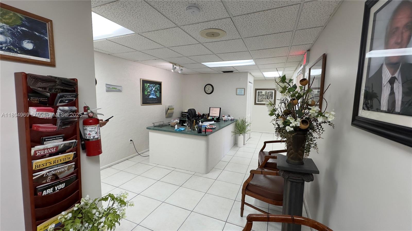 An office reception area features a service counter, tiled floors, and framed wall art — 8315 SW 24th St # B, Miami FL 33155, MIAMI, FL