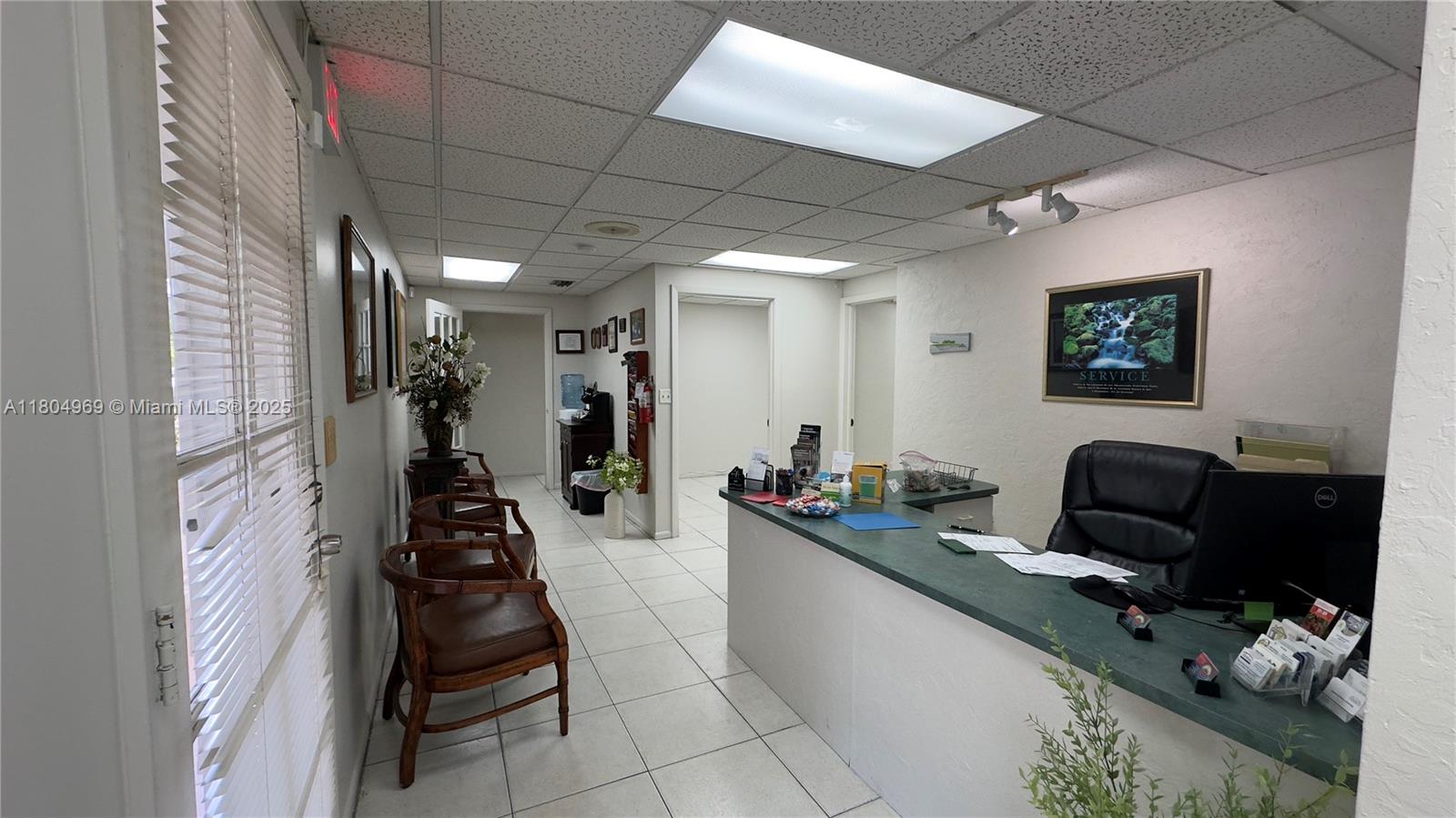 A reception area features a front desk, waiting chairs, and white tiled flooring — 8315 SW 24th St # B, Miami FL 33155, MIAMI, FL