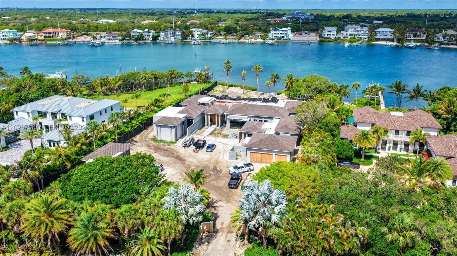 An aerial view shows a large, modern house under construction near a waterfront — 508 S Beach Rd, Jupiter Island FL 33455, JUPITER ISLAND, FL