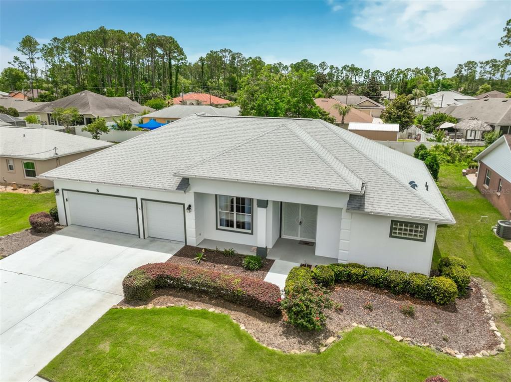 An aerial view of a white single-story house with a gray roof and two-car garage — 8 EASTGATE LANE, PALM COAST, FL