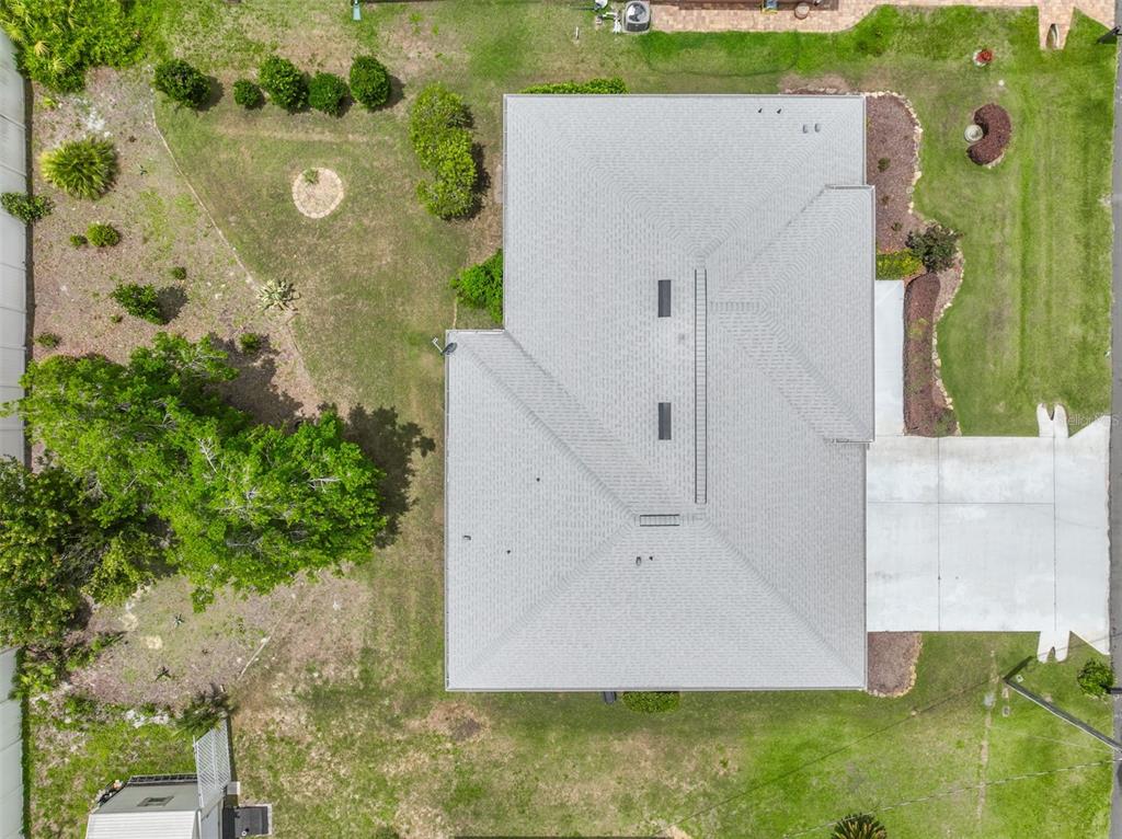 An aerial view shows a house with a gray shingled roof and a concrete driveway — 8 EASTGATE LANE, PALM COAST, FL