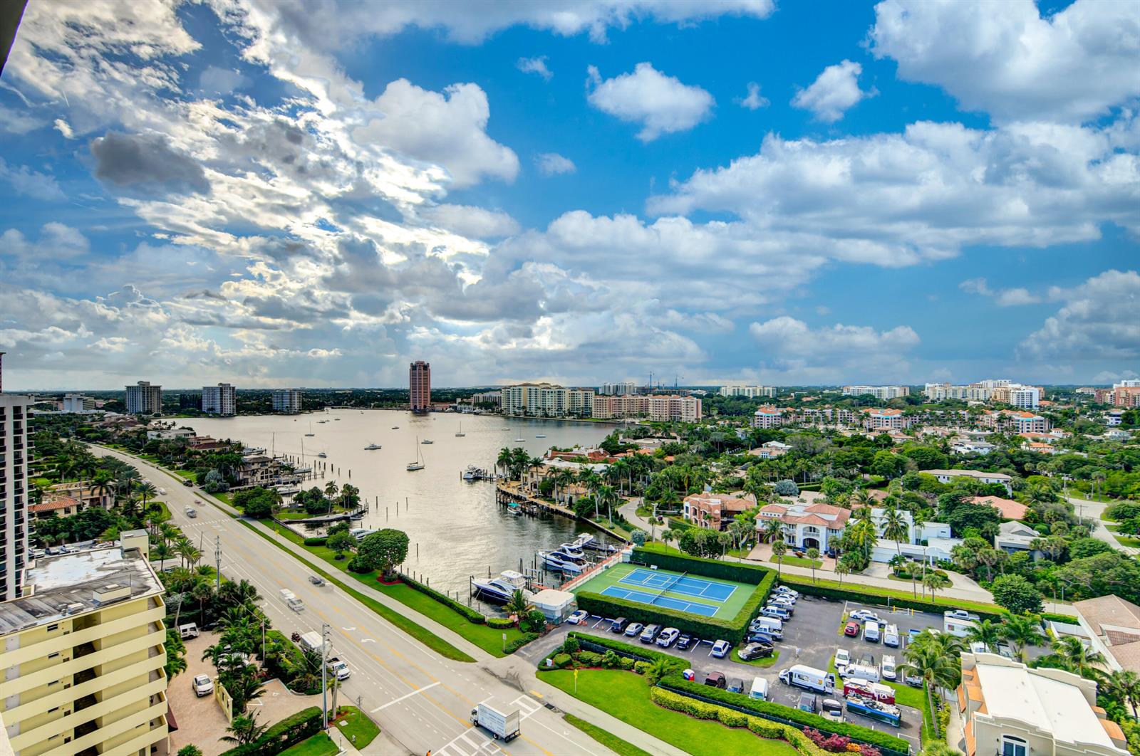 An elevated view of a coastal city featuring a waterway, tennis courts, and residential buildings — 250 S Ocean Boulevard # c, Boca Raton FL 33432, BOCA RATON, FL