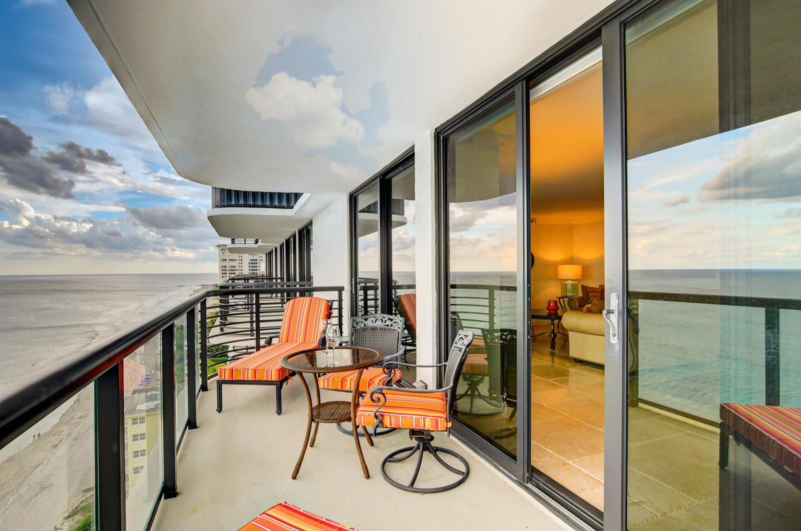 A balcony with outdoor furniture overlooks the ocean and a sandy beach — 250 S Ocean Boulevard # c, Boca Raton FL 33432, BOCA RATON, FL
