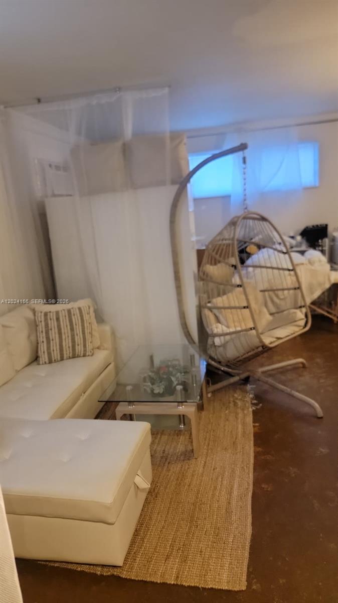 A living area features a white sofa, a glass coffee table, and a hanging egg chair — 1751 Washington Ave # 1H, Miami Beach FL 33139, MIAMI BEACH, FL