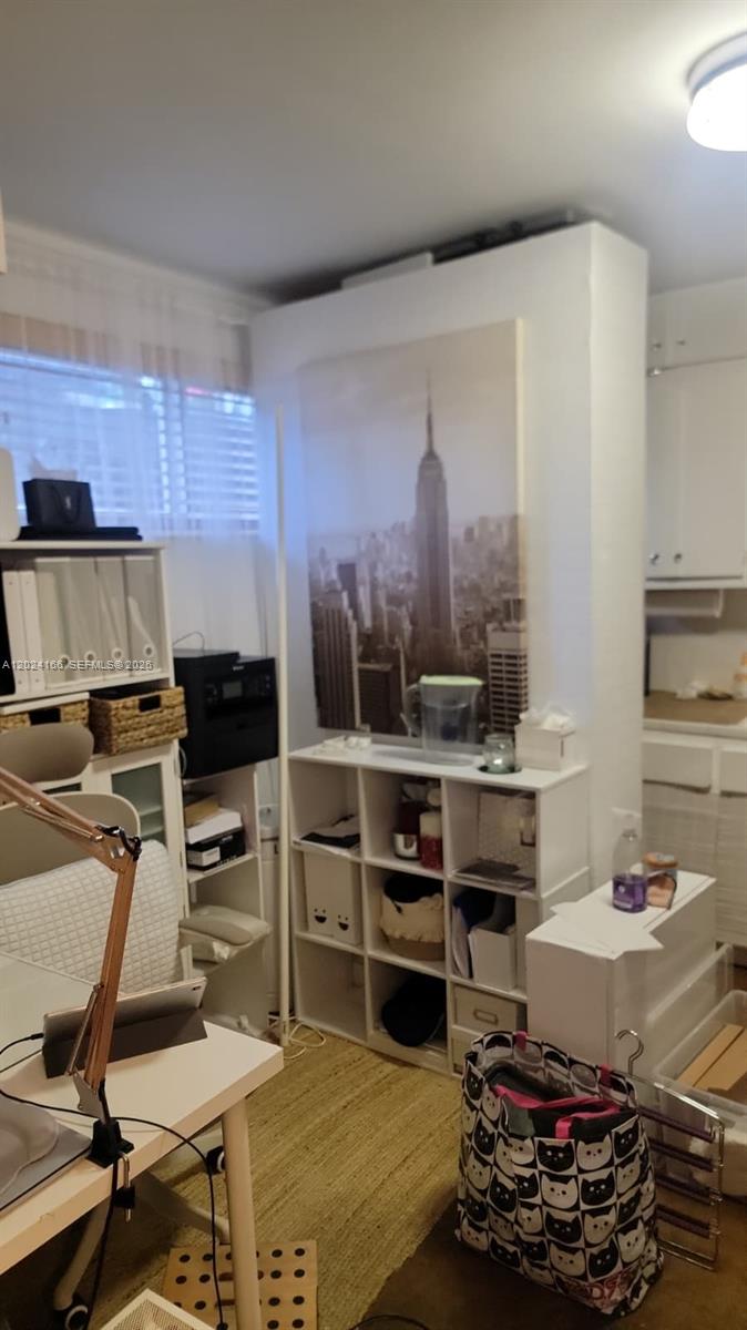 A home office features a desk, white cube storage shelving, and a large city skyline print — 1751 Washington Ave # 1H, Miami Beach FL 33139, MIAMI BEACH, FL