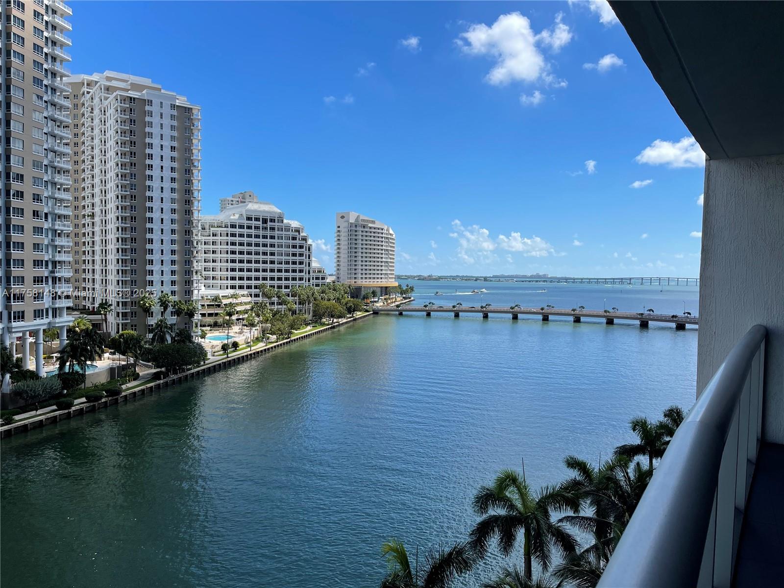 A high-angle view shows a waterfront canal, a bridge, and several tall residential buildings — 465 Brickell Ave # 819, Miami FL 33131, MIAMI, FL