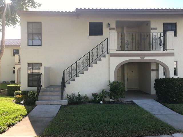 A two-story stucco apartment building features an exterior staircase and a ground-level arched entryway — 2650 Greenwood # G216, Boca Raton FL 33431, BOCA RATON, FL